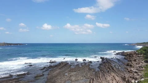 Ocean, rock, and blue sky Stock Footage
