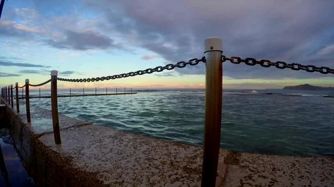 Ocean rock pool at sunset, with clouds passing overhead. Motion time lapse. Video stock 75820390