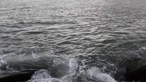 Ocean on rocks, Ocean City MD inlet, Assateague Island Stock Footage 74643041