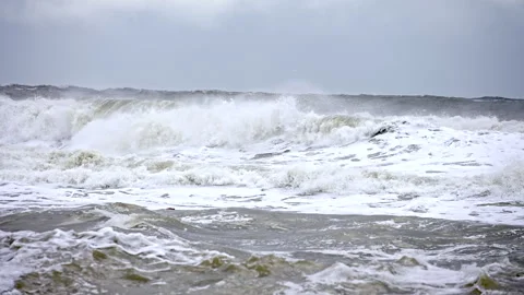 The ocean is rough and choppy, with waves crashing against the shore Stock Footage 298263098