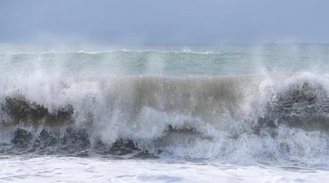 The ocean is rough and the waves are crashing against the shore. Stock Photos