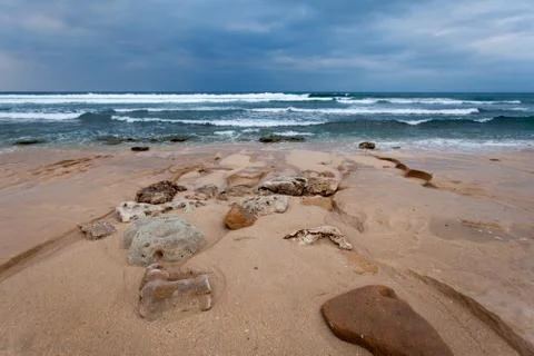 Ocean with round craters on the shore Stock Photos