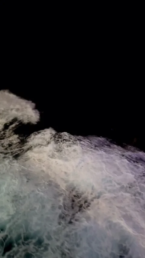 Ocean sailing in night darkness, waves and boat wake, moonlight, vertical Stock Footage 311452420