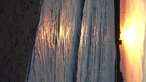 Ocean sandy beach and waterfront in Cadiz Spain in evening during fire sunset. Vidéo 240188986