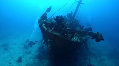 Ocean scenery diver deep below bow turns on lights, on wreckage, HD, UP27565 Stock Footage 62213907