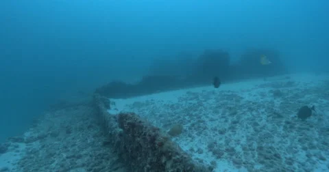 Ocean scenery fairly empty deck partly buried in sand, on wreckage, 4K UltraHD, Stock Footage 61951985