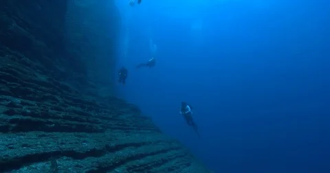 Ocean scenery shear wall of stratified layers of rock and strong surge, on Stock Footage 82593293