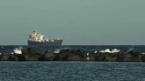 Ocean with a ship at anchor in the background Stock Footage 310265941