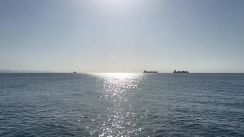 Ocean with Ships on the Horizon Under Bright Sunshine and Clear Blue Sky Stock Footage 307632155
