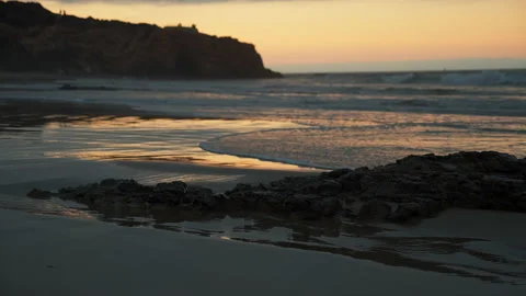 Ocean shore in the evening at sunset, sun glares on the wet sand on the beach Stock Footage 150907580