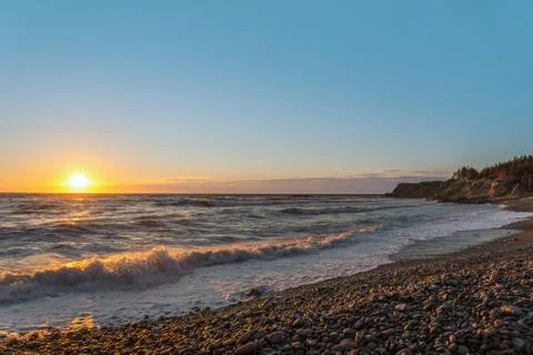 Ocean shore at sunset Stock Photos