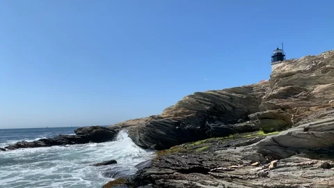 Ocean Shoreline Rock Cliffs with Waves Crashing with Lughthouse 스톡 동영상 116346990