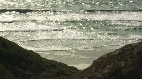 Ocean shot through a v- shaped rock formation Stock Footage 64220819