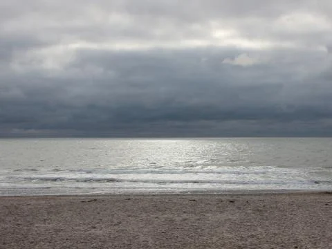 Ocean with Silver Surface and Dark Cloudscape Stock Photos