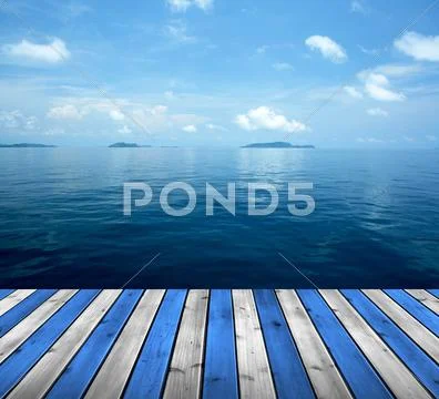 Ocean with sky and wood floor Stock Photos