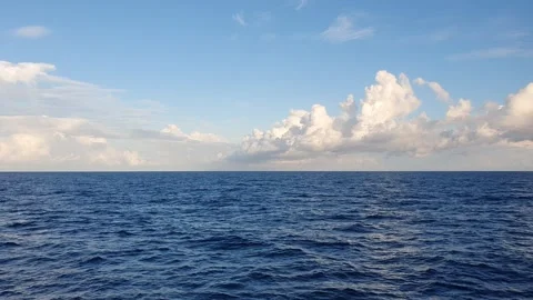 Ocean, small waves, blue sky and white clouds 動画素材 336223370