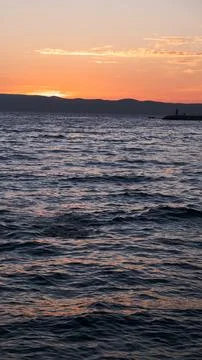 Ocean small waves on sunset lights. 库存照片