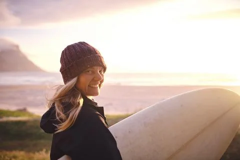 The ocean is so inviting. an attractive young woman out surfing in the Stock Photos