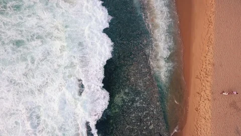 Ocean splash on a beautiful sandy beach at evening aerial view Video stock 80279026