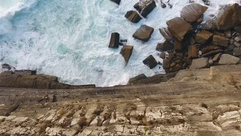 Ocean splash at rocky beach evening aerial view Stock Footage 80279280