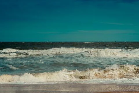 Ocean storm waves dramatically crashing splashing. Sky horizon line. Sea water Stock Photos