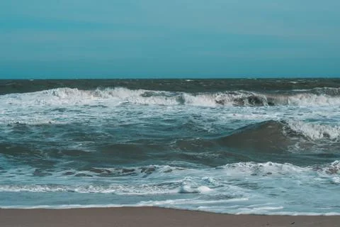 Ocean storm waves dramatically crashing splashing. Sky horizon line. Sea water Stock Photos