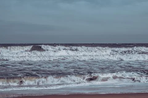 Ocean storm waves dramatically crashing splashing. Sky horizon line. Sea water Stock Photos