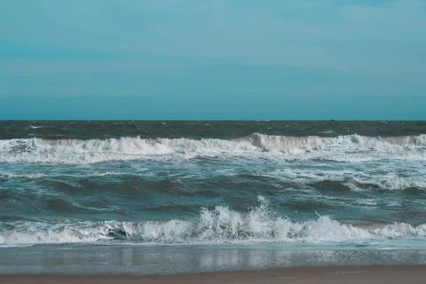 Ocean storm waves dramatically crashing splashing. Sky horizon line. Sea water Stock Photos