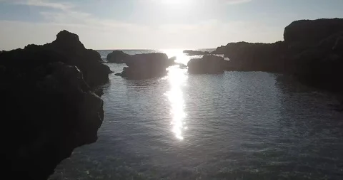 Ocean Sun and Rocks Drone Shot Stock Footage 106340363