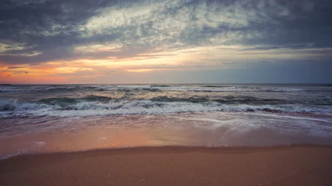 Ocean sunrise over the beach with dramatic cloudscape Stock Footage 139223931