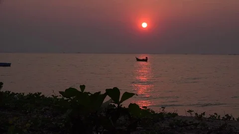 Ocean sunset and small boat. Видео 83186604