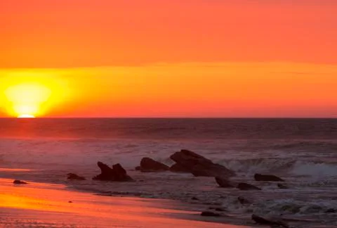 Ocean sunset on the beach and the Pacific Ocean in Punta Sal, Peru Stock Photos