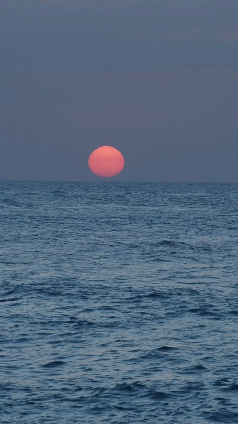 Ocean sunset. Big orange sun touching horizon, Atlantic Ocean water. Stock Footage 275543239
