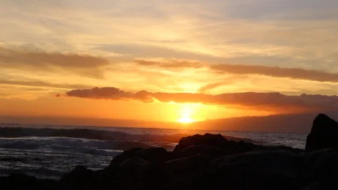 Ocean sunset with cloud, crashing wave and yellow, orange and red sky. HD Video Stock Footage 97939393