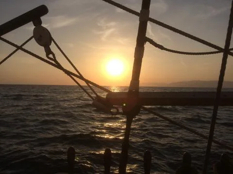 Ocean sunset from deck of tall ship Stock Photos