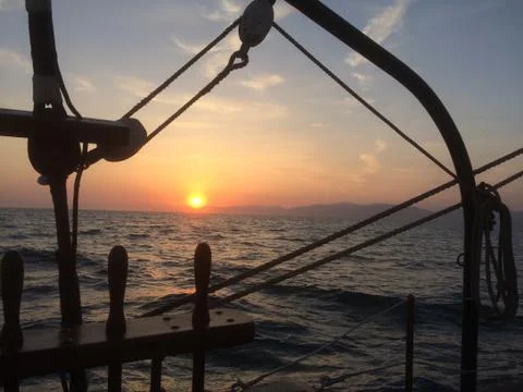 Ocean sunset from deck of tall ship Stock Photos