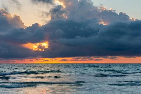 Ocean Sunset with Dramatic Dark Clouds Stock Photos