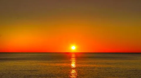 The ocean with a sunset Stock Photos