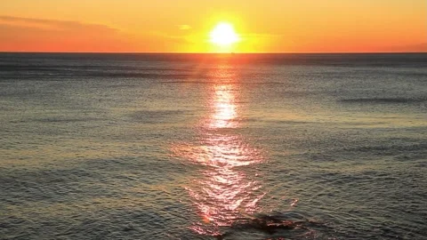 Ocean sunset reflection glows fiery sky Bogliasco Italy winter Stock Footage 326465510