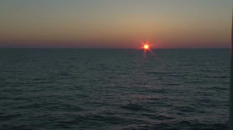 Ocean sunset resting on the horizon Stock Footage 11202418
