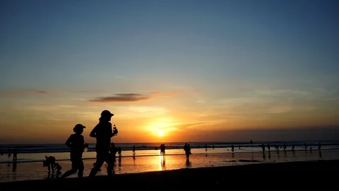 Ocean sunset with running people Stock Footage 110733425