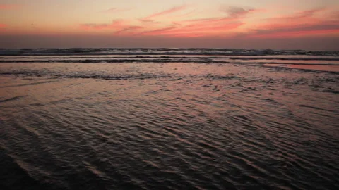 Ocean sunset. from seashore with undercurrent and small waves. Stock Footage 285152691