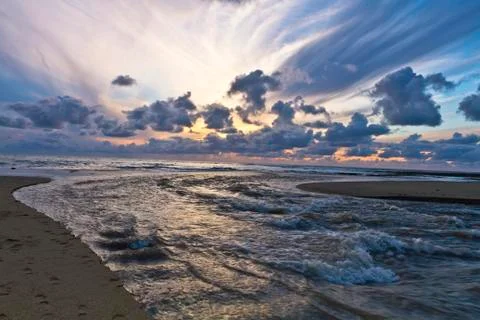 Ocean sunset with stream Stock Photos