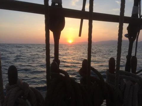 Ocean sunset from tall ship Stock Photos