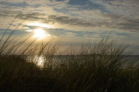 Ocean Sunset View With Grass In foreground Stock Photos