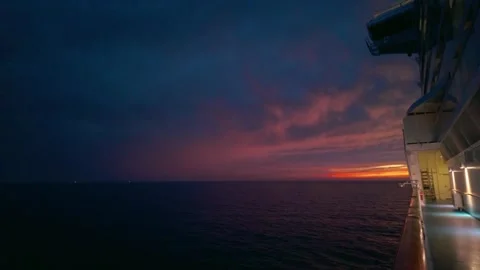 Ocean sunset viewed from a ship's deck vivid hues blending in the evening sky Stock Footage 324443689