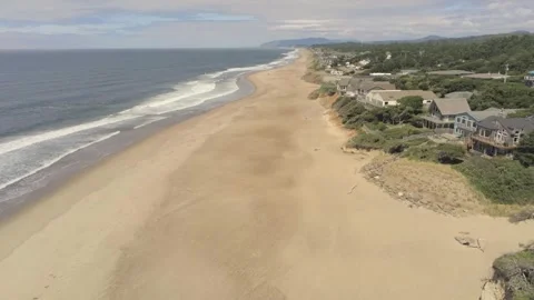 Ocean surf, beach, and beach houses near Depoe Bay Oregon Stock Footage 246834170