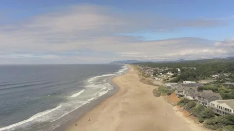 Ocean surf, beach, and beach houses near Depoe Bay Oregon Stock Footage 246834190