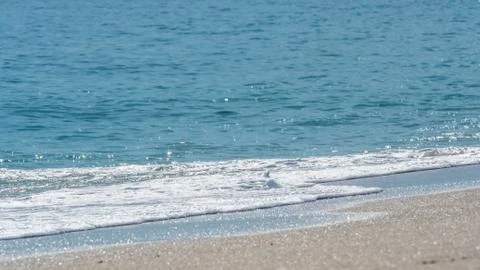 Ocean surf on the sandy beach Stock Photos