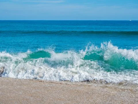 Ocean surf on the sandy beach Stock Photos